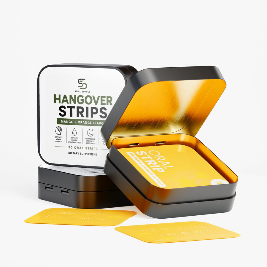 Still Supply Hangover Strips tin open, with two mango and orange strips beside it